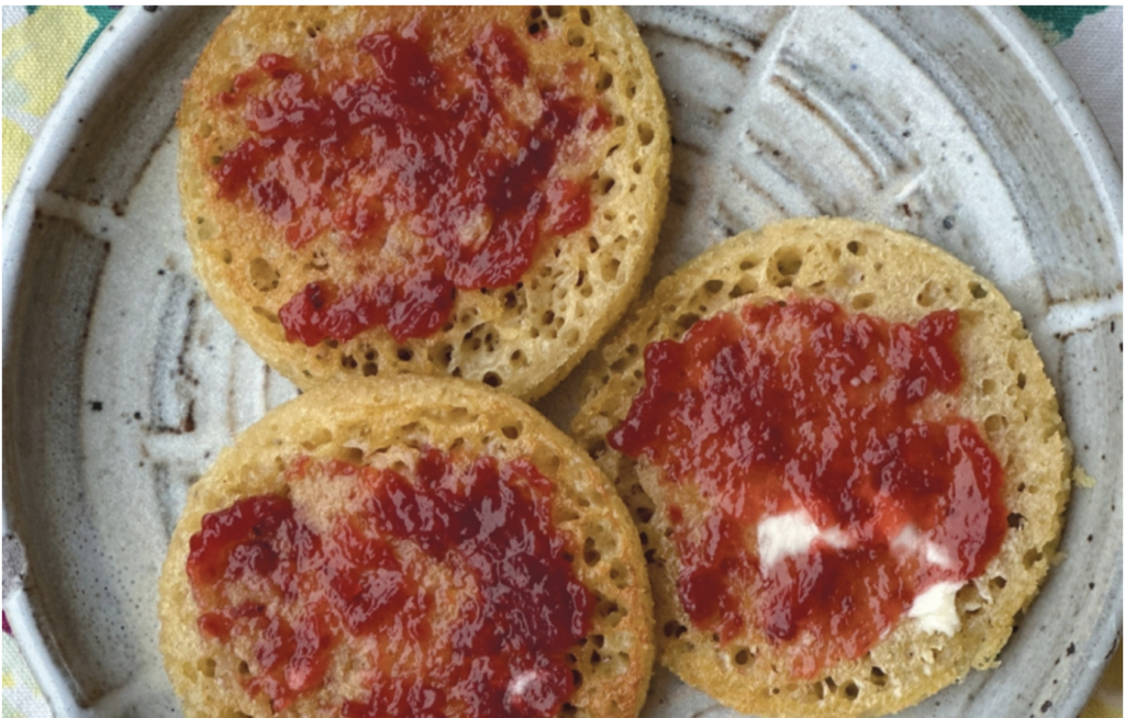 Crumpets on a plate covered with jam